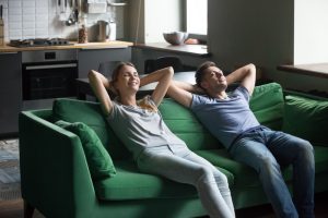 couple-relaxing-on-couch-in-home