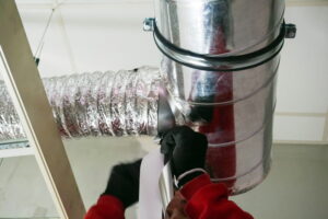 gloved-hands-working-on-ductwork