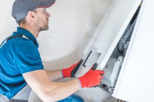 Technician placing cover back on heater.