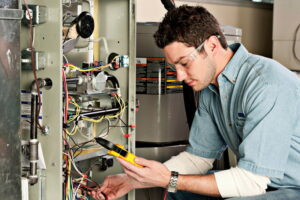 Technician servicing a furnace.